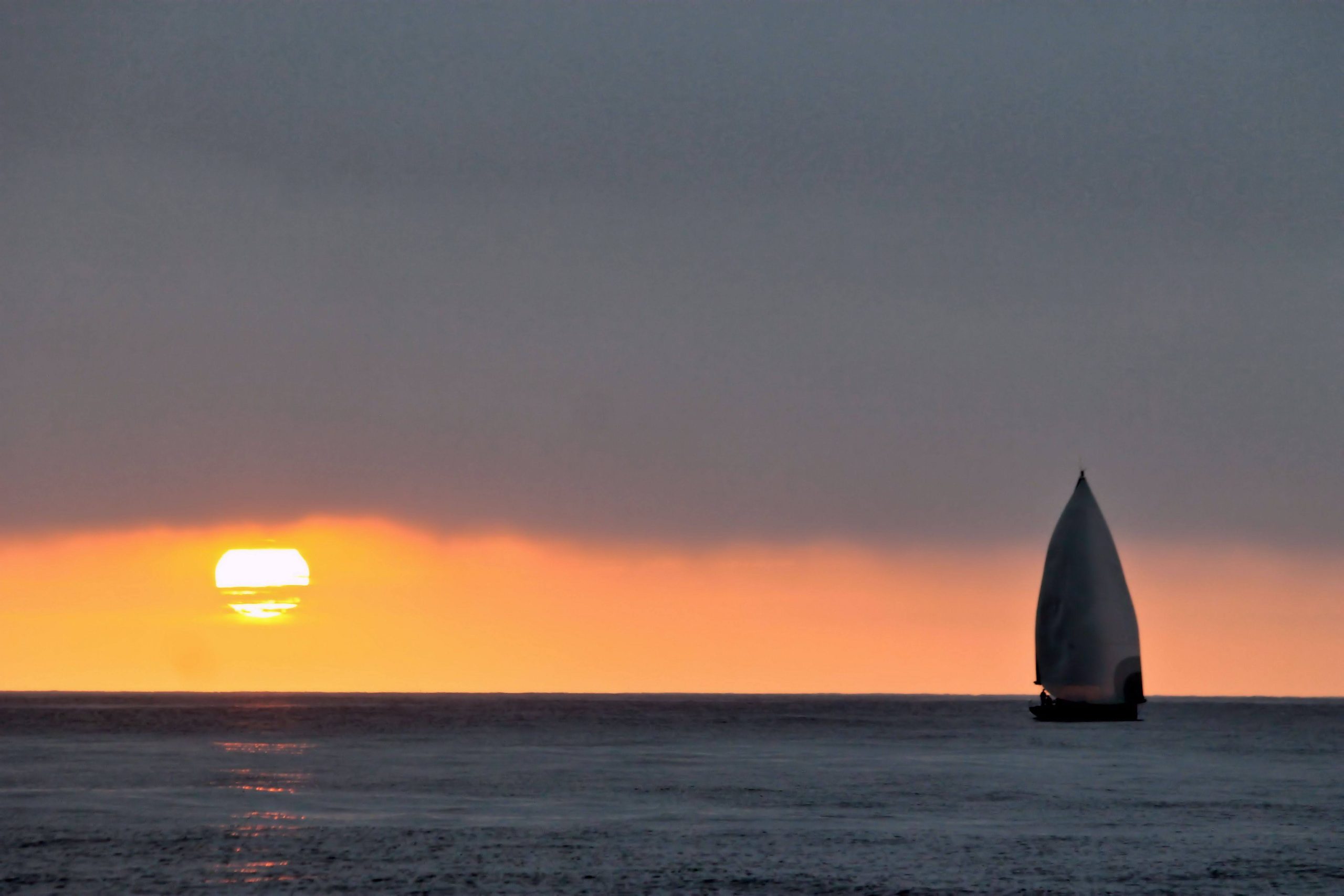 A private sunset cruise aboard Blackwing as the sun sets over the Pacific off Dana Point